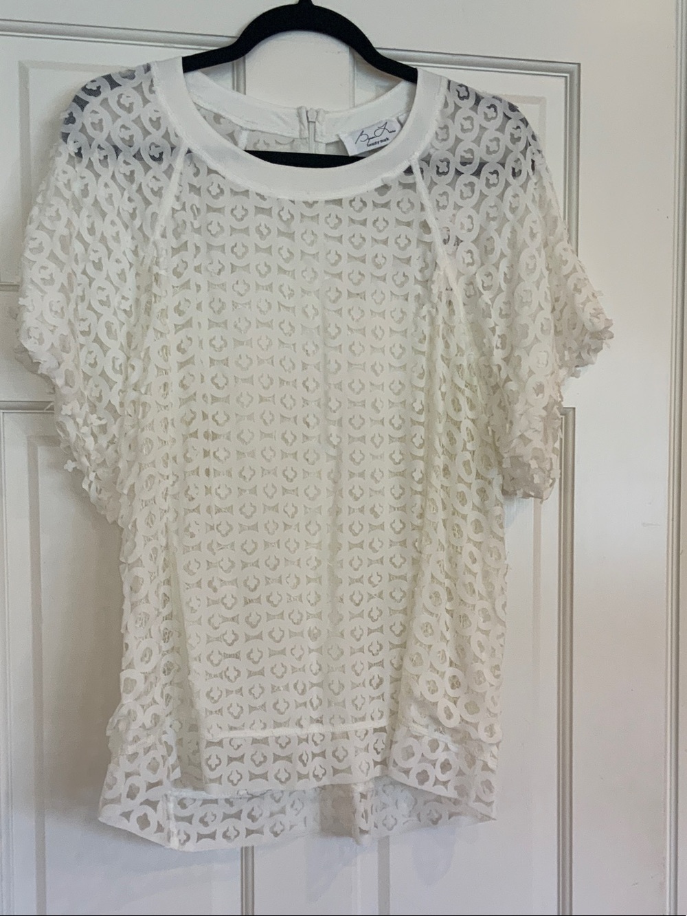 Beautiful laser cut blouse by Anthropologie